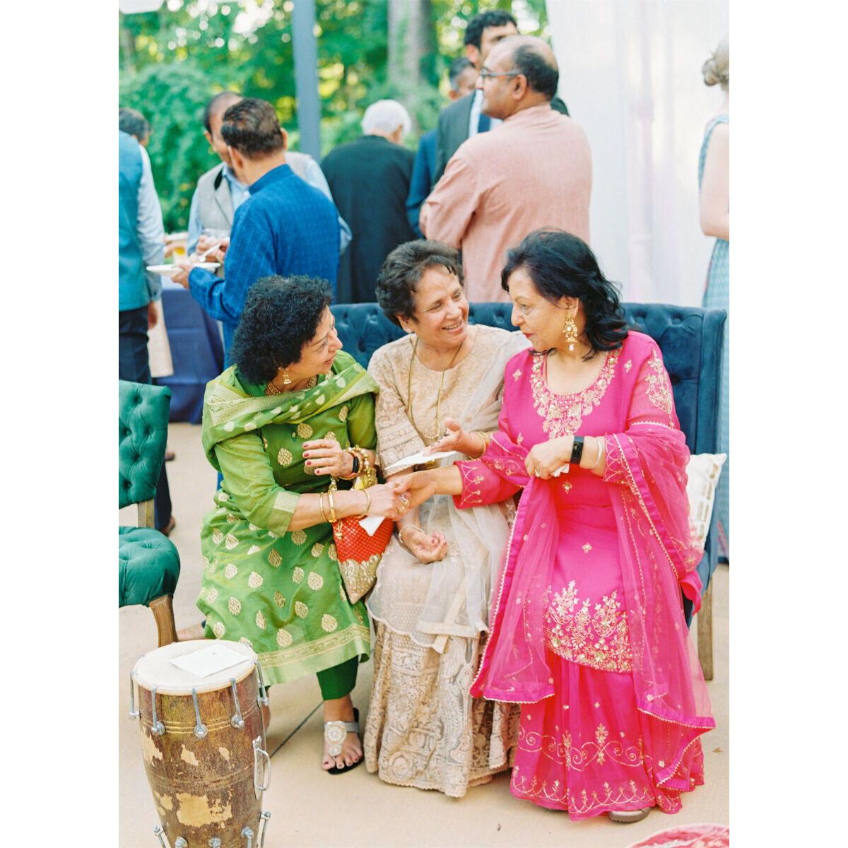 Rich and vibrant colors are encouraged. Whites and creams are also okay at Pooja. Pictured is a green women's Kurta and pant set, and pink women's Kurta and skirt set
