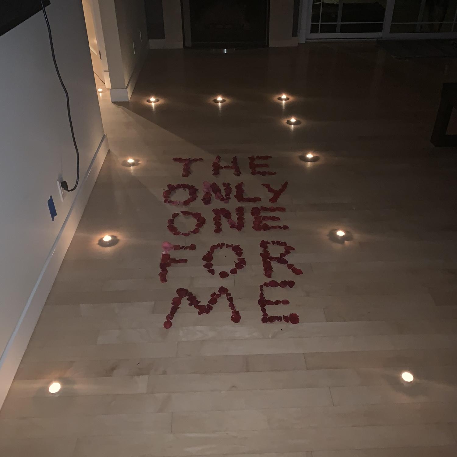 he won her over with rose petals and candle light