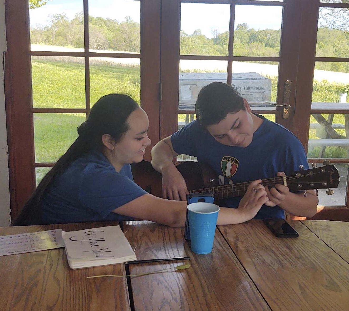 May 13, 2020. Trying to teach Luke the guitar
