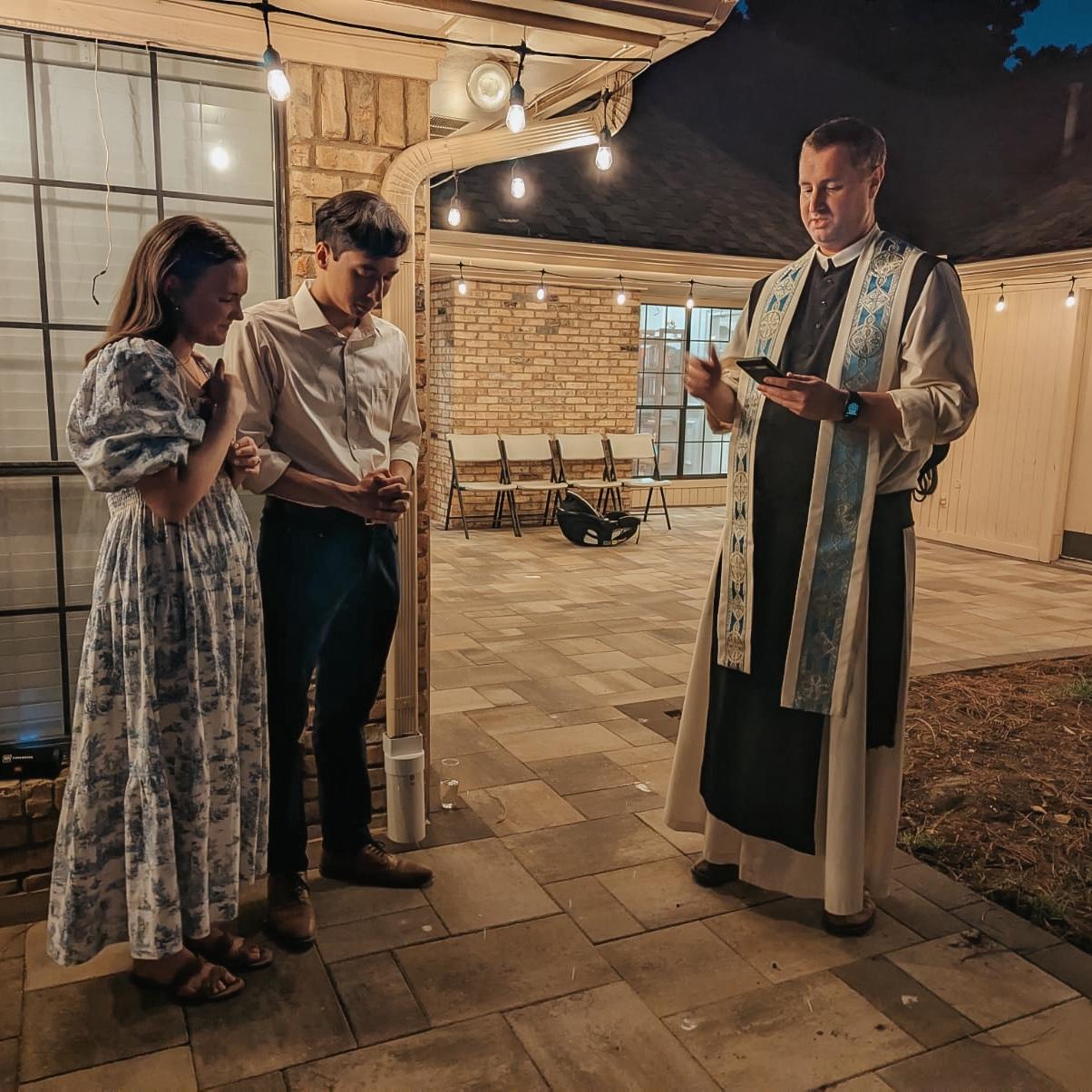 Receiving a blessing from Fr. Anthony at our engagement party!