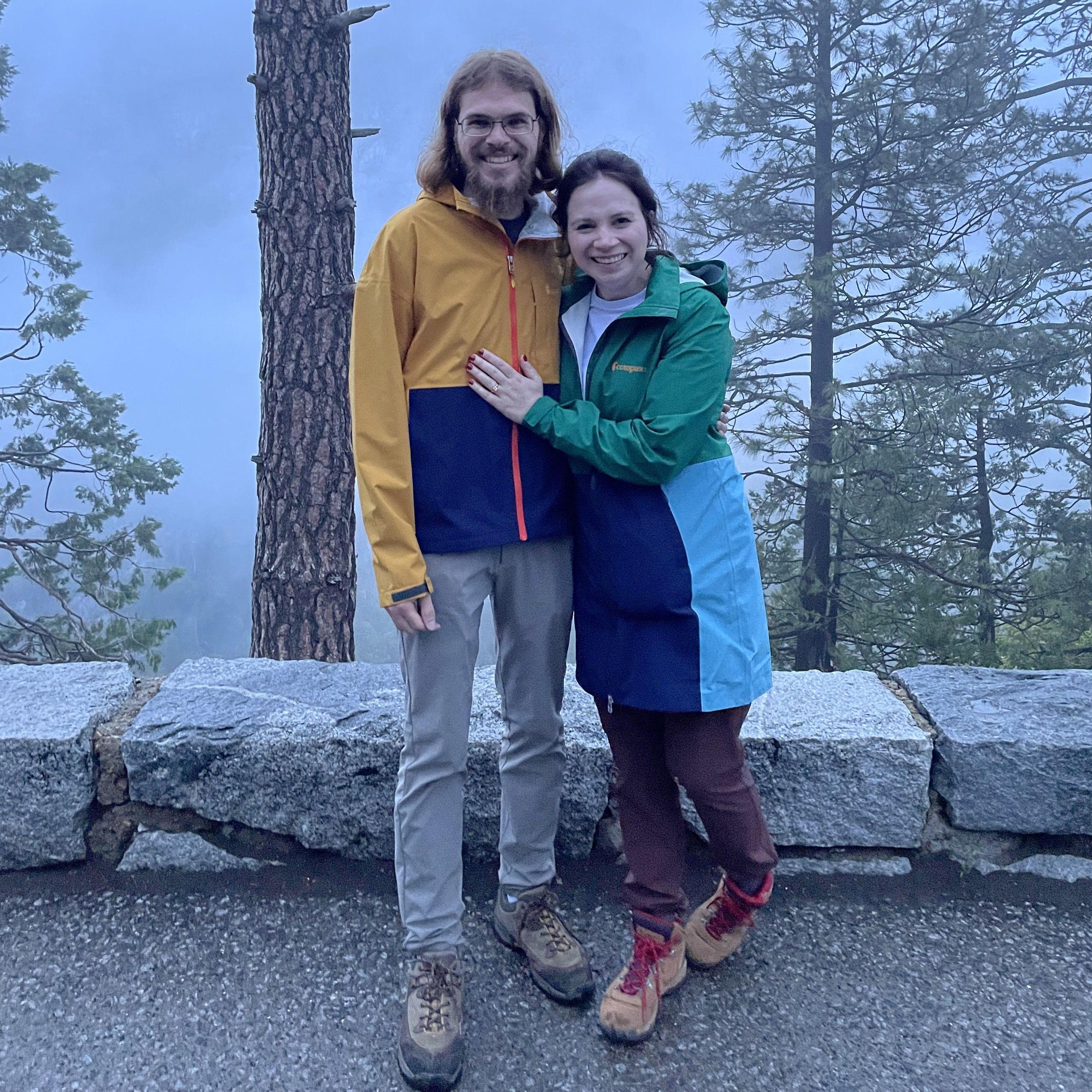 The stranger who took this photo was the first person we told that we we're engaged! The Yosemite Valley is behind us, but the fog is too dense to see through.