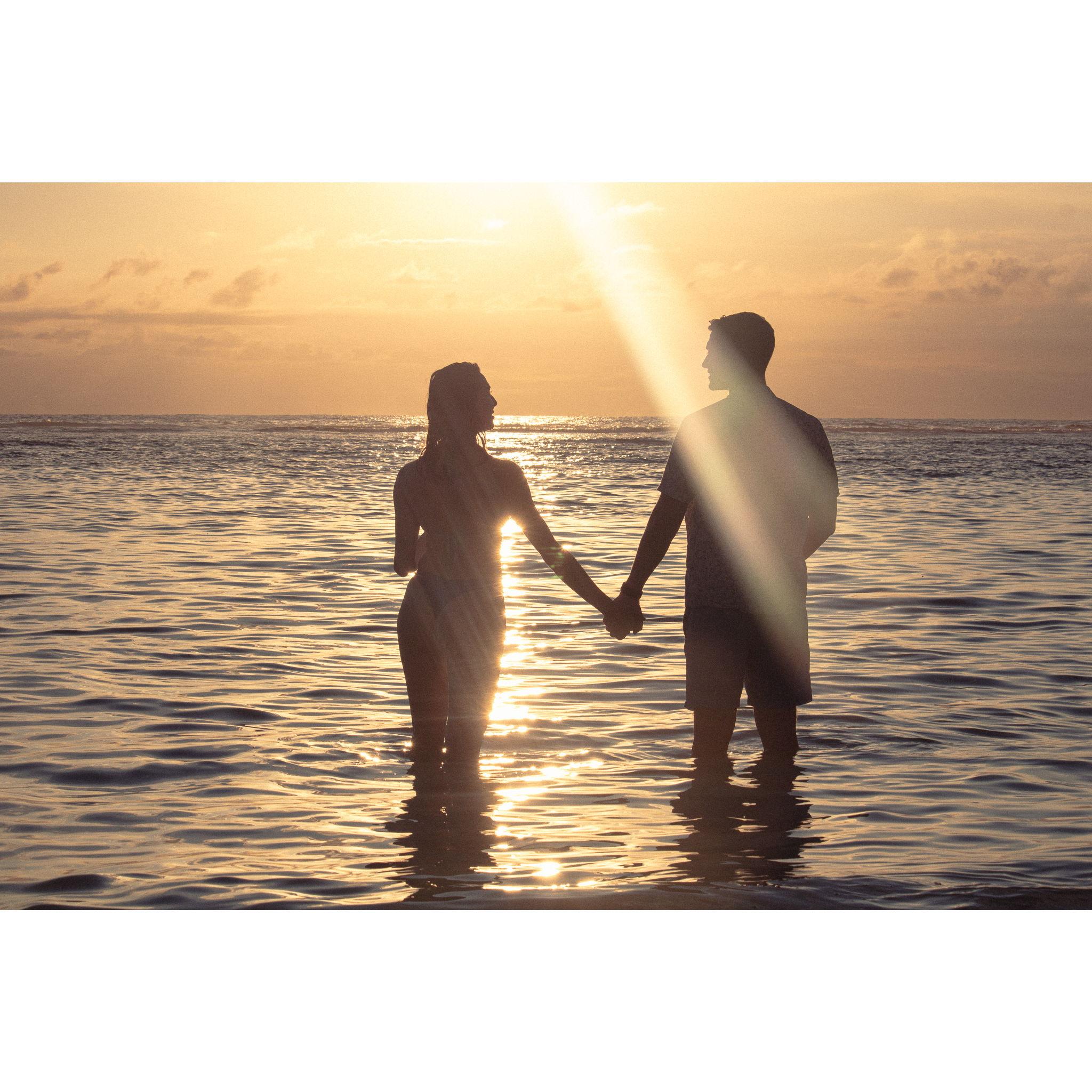 Holding hands at sunset in the Seychelles.