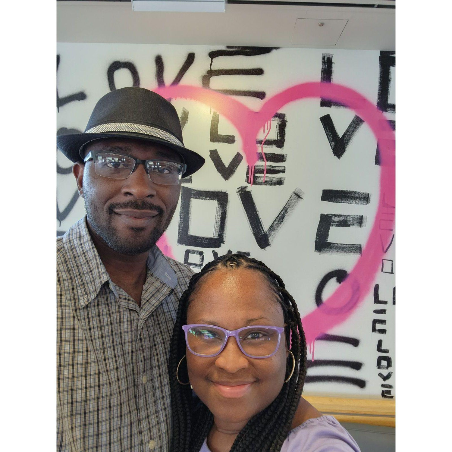 On this special day (8/18/2023) Cory proposed during a trip in Atlanta for a reunion with Cory's relatives. Prior to the proposal, we took a photo in front of the artwork at the airport that was created by Cue Perry.