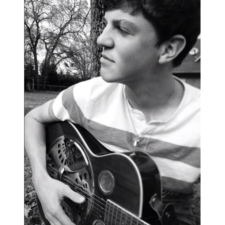 Brock playing my Poppy's guitar in the front yard of his parents' old house. 2012