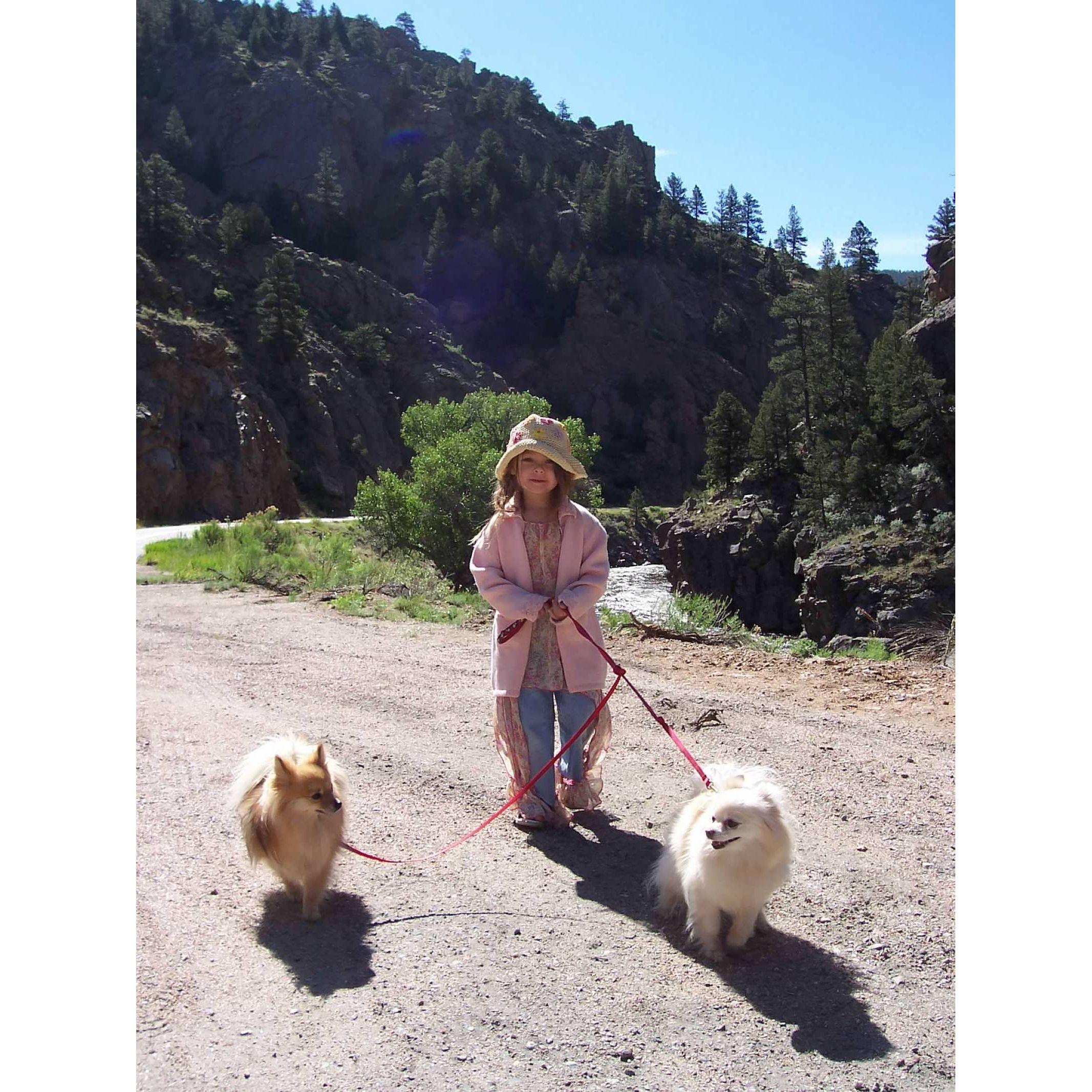 Maddie walking the dogs as a child in Estes park