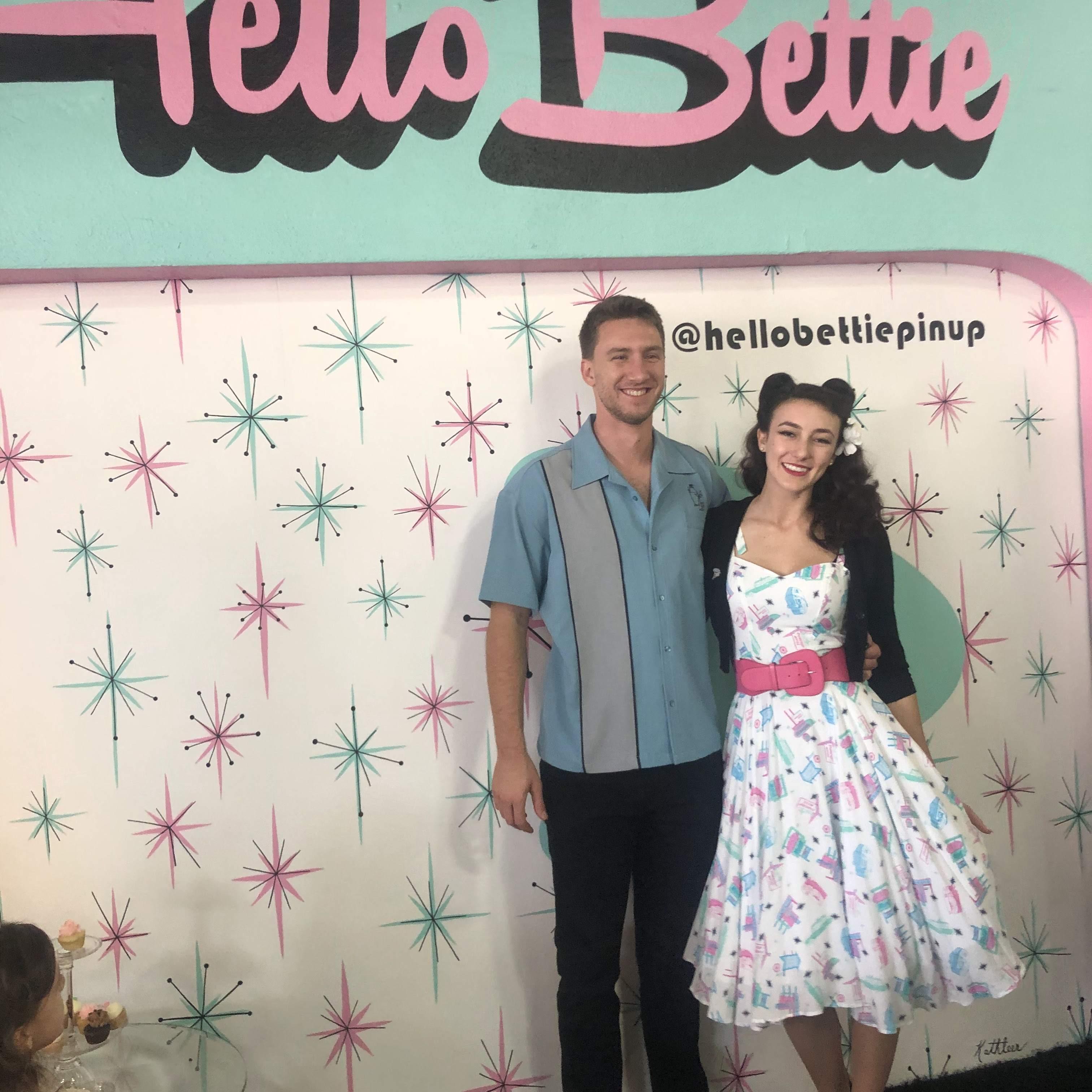 Grand opening of Hello Bettie & Chris is modeling the wares.