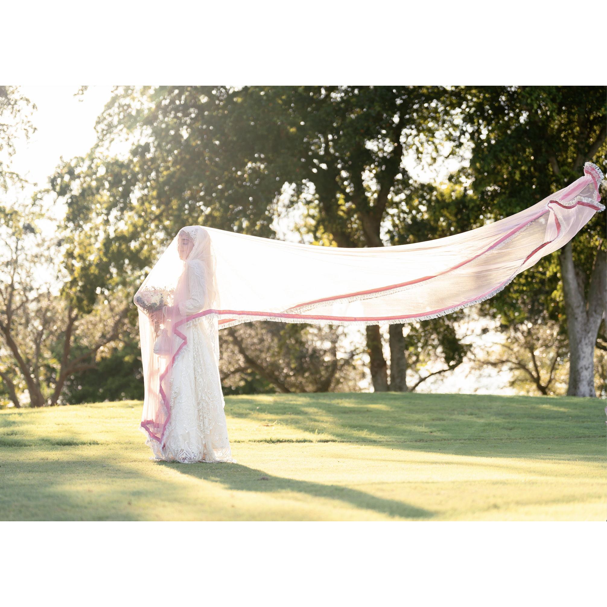 Huda (bride's twin sister) lifted Sana's veil and ran out of the frame for this picture.