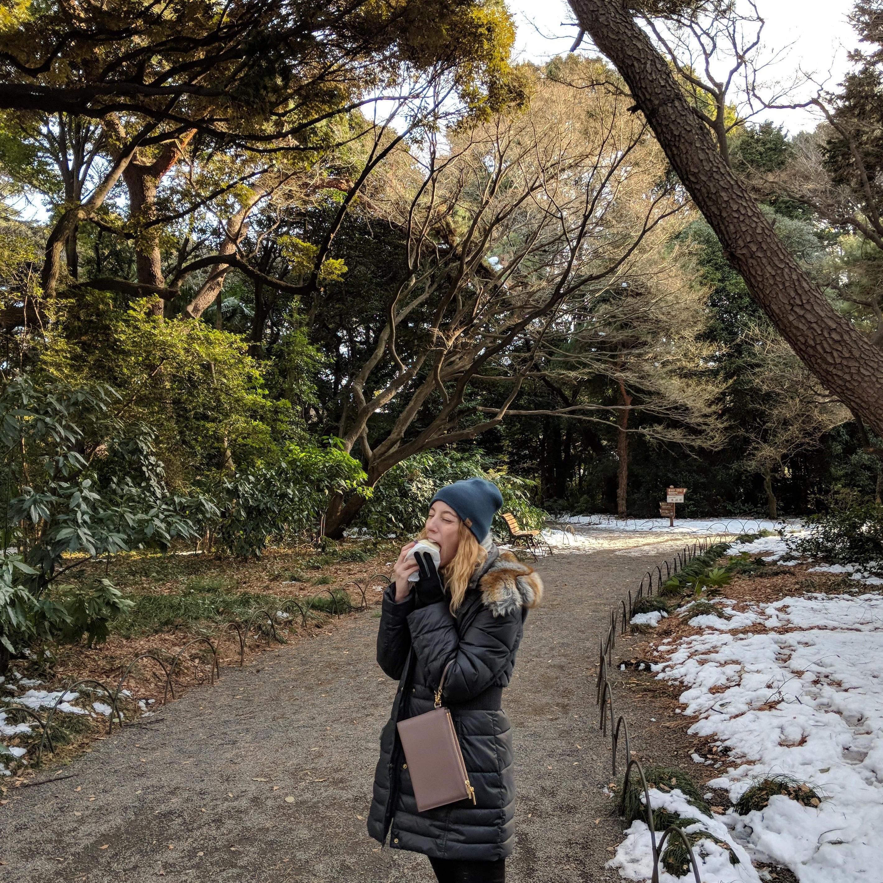 Eating a massive pork bun on our walk through the beautiful Shinjuku Gyoen National Garden in Tokyo, Japan