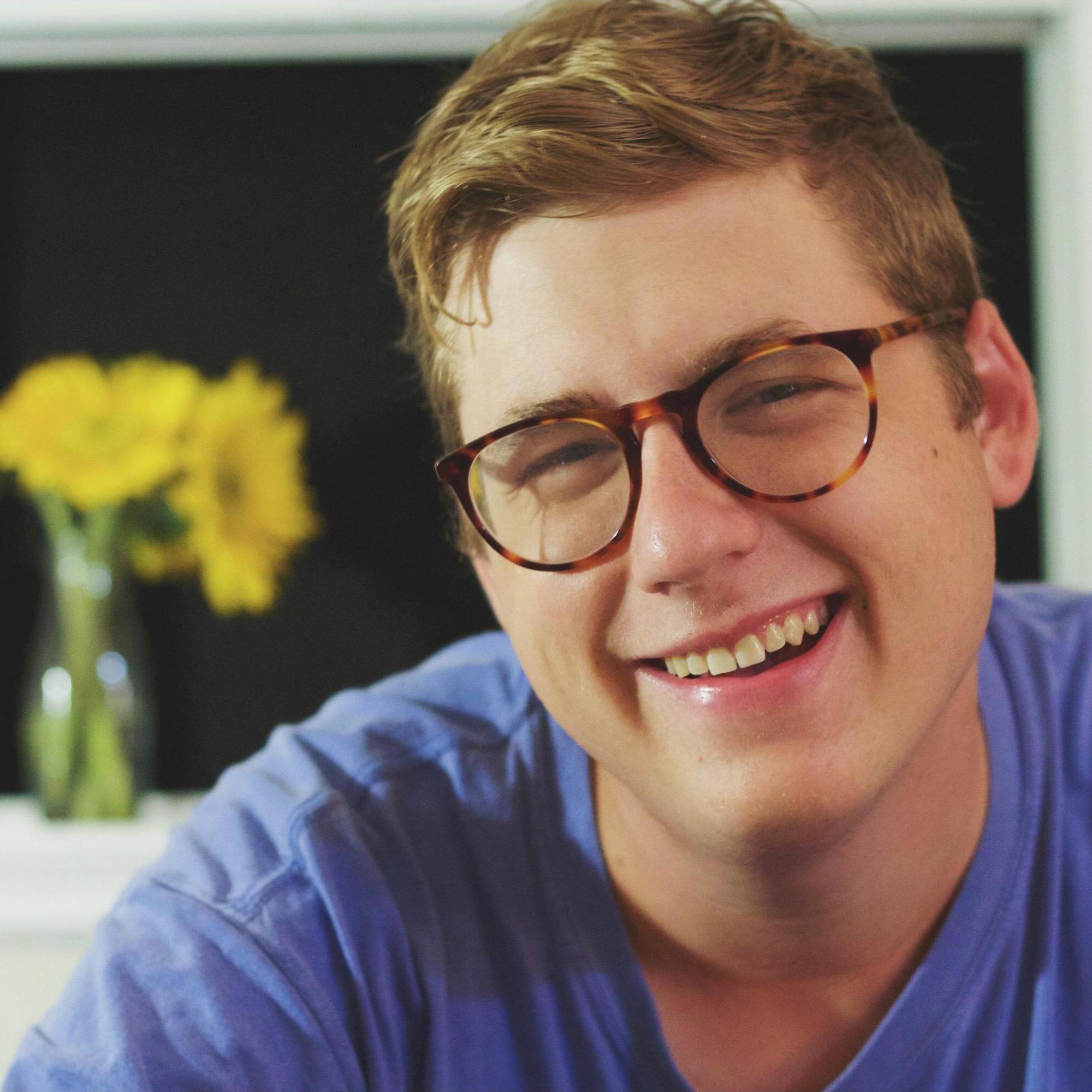 A photo I took of Phil in my dorm room, flowers courtesy of him.