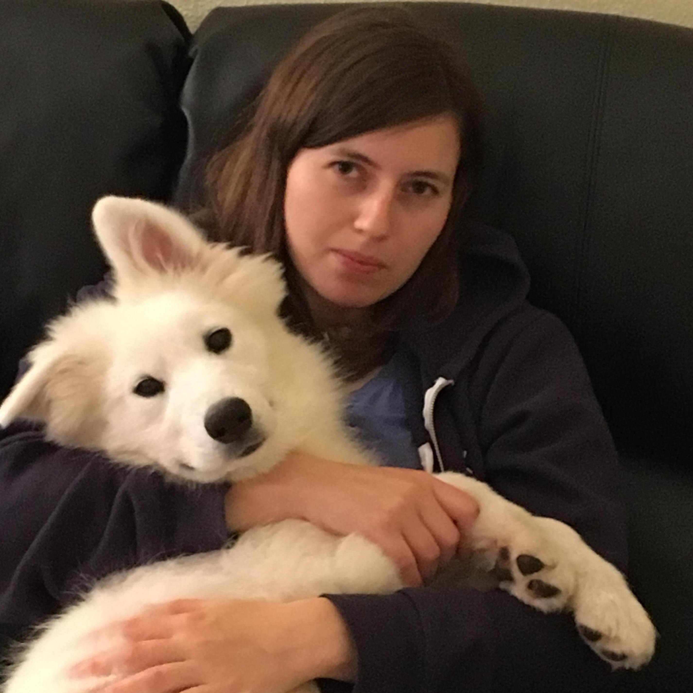 A giant rabbit with dog paws cozies up to Sara while Mookie looks on in anguish.