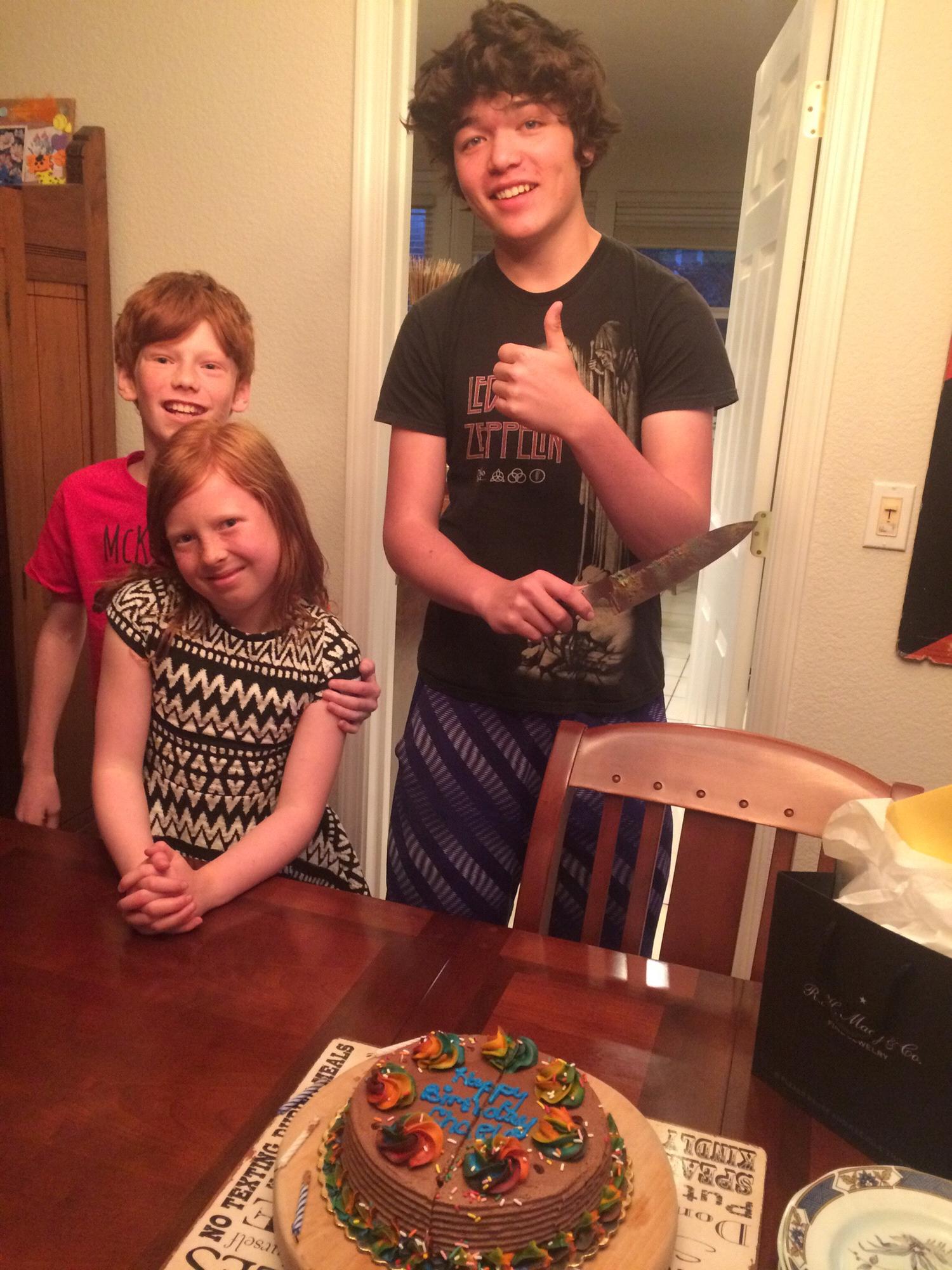 Chaela's 39th birthday. Payton about to cut the bday cake....surprise! We are engaged! You are about to have step-parents kiddos!