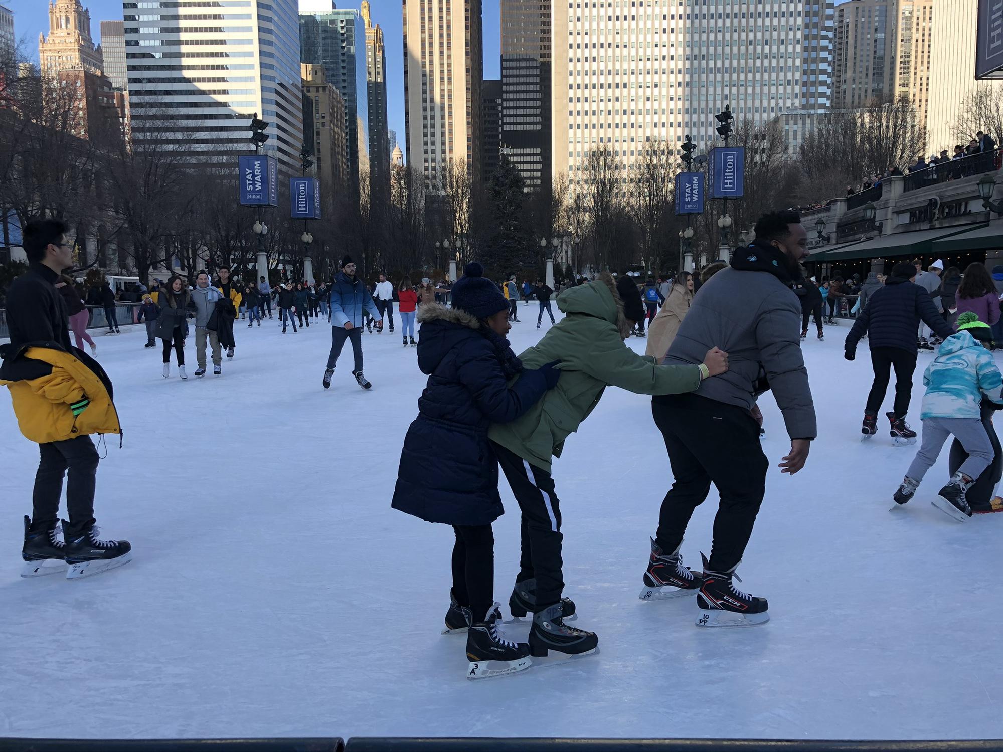 Jayson teaching the kids how to ice skate in Chicago (2019)