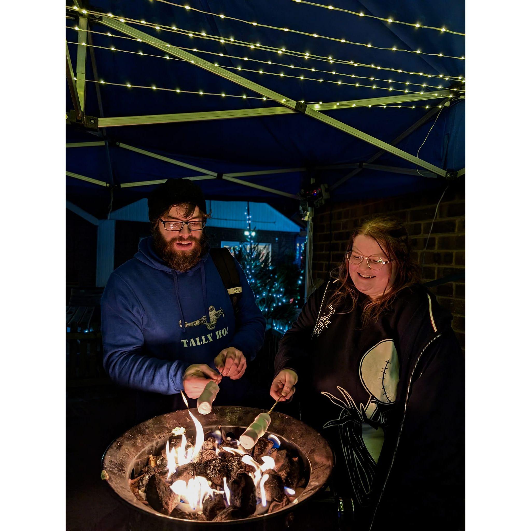 Tom trying to demonstrate the right way to toast marshmallows at light post farm over the christmas period.