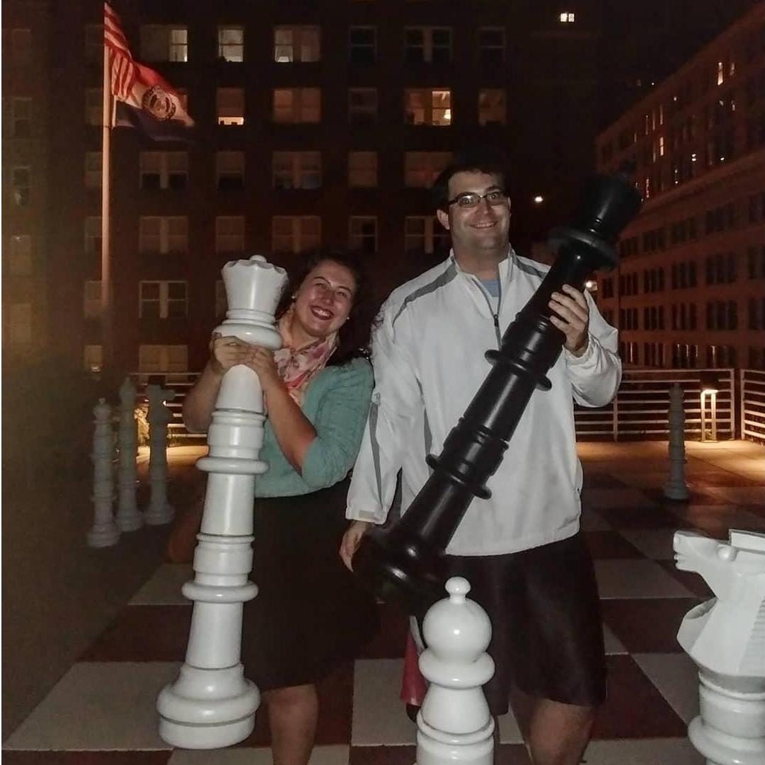 Alex and Andy play giant chess on the roof of the downtown KC library