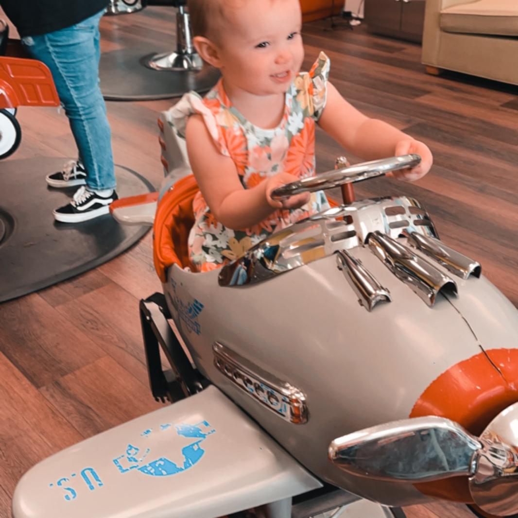 Taking after her daddy! Riding along with Vance and Nana for his haircut!