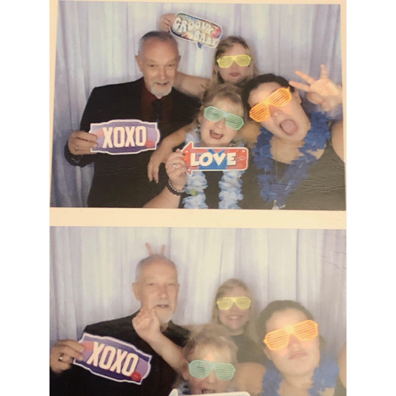 Grandpa, Grandma D, Carol, & Kayla in the photo booth at a wedding