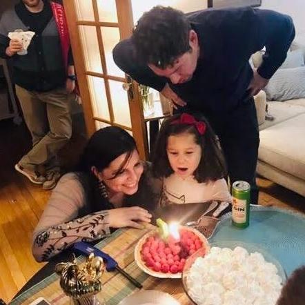 Making wishes for Valentina's birthday celebration, with Manny's help!