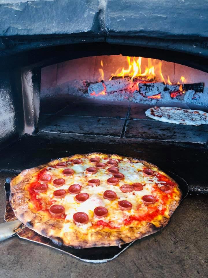 Hand tossed wood fired pizza will be served at the party