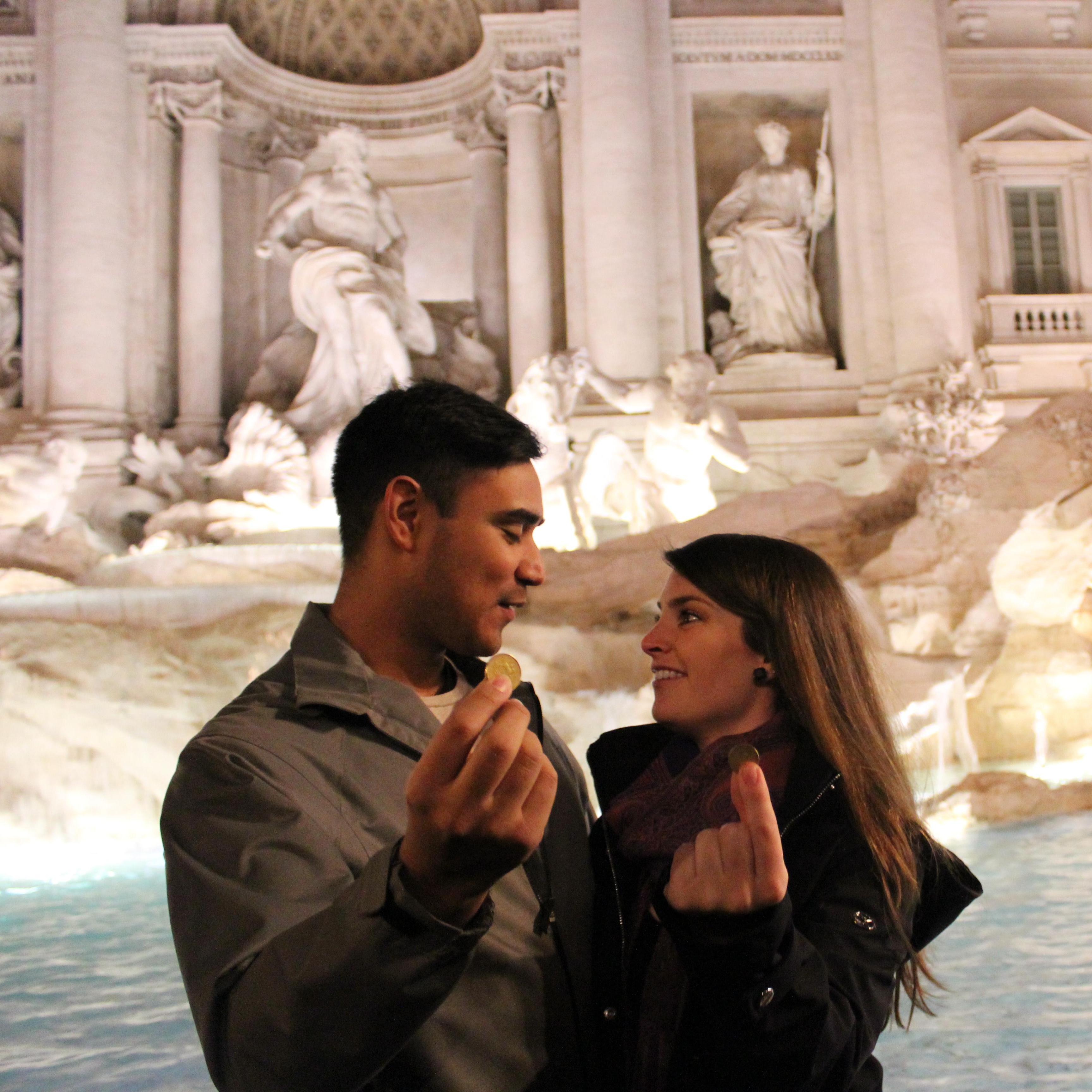 Making a wish at Trevi Fountain in Rome, Italy