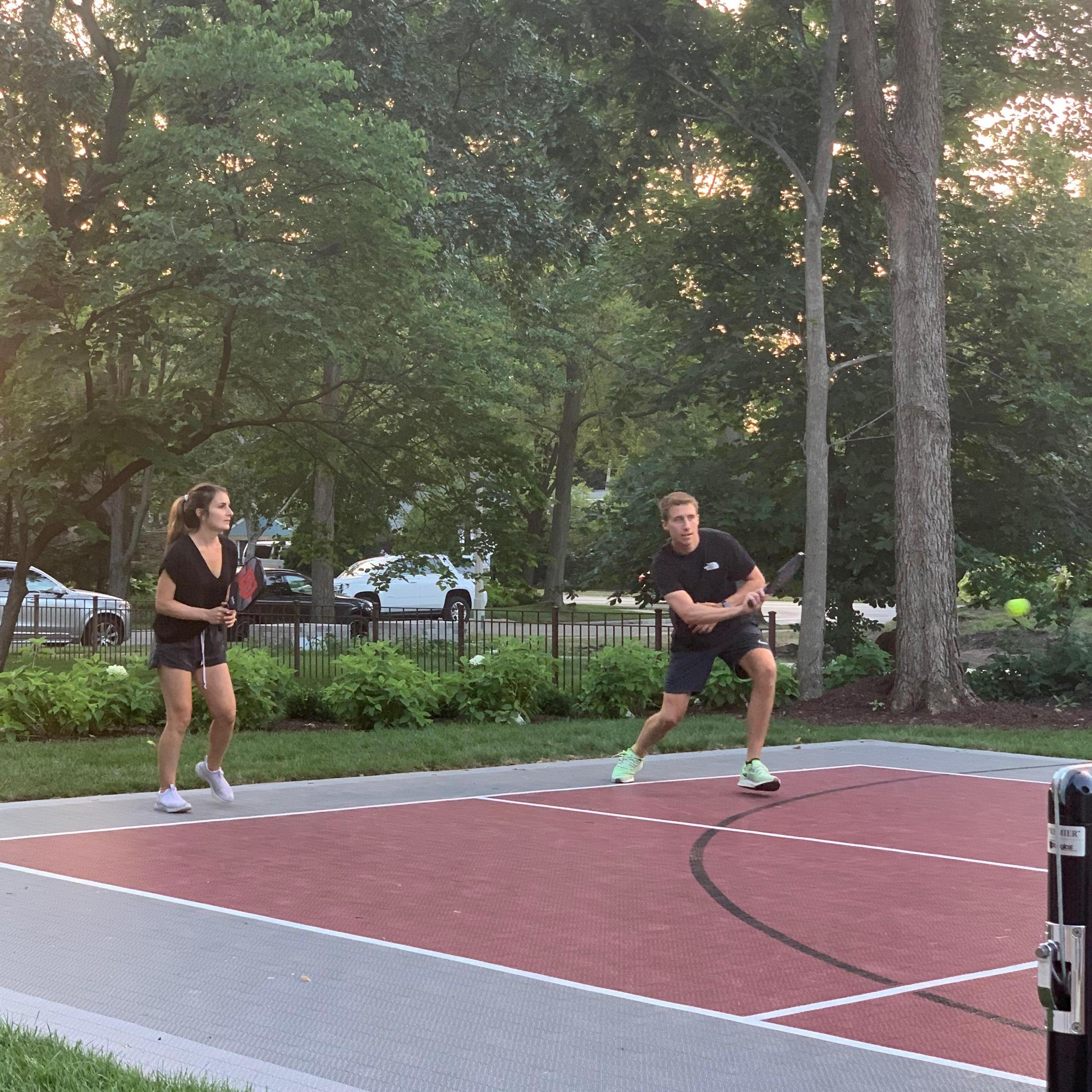Freddy attacking the net as Emma plants her feet at the baseline...with no intention to move.