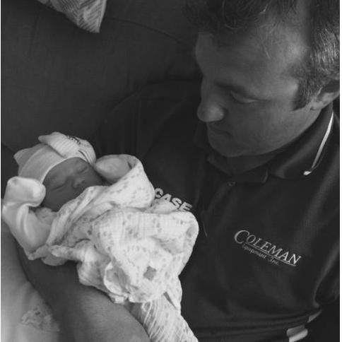 John holding newborn baby Harlow for the first time, clearly smitten.