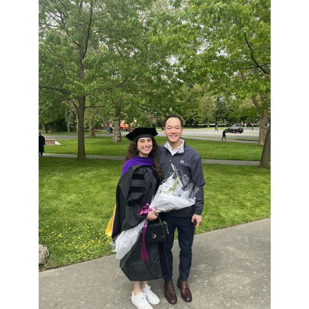 Ahbra at her law school graduation, with her dutiful emotional-support-Alvin by her side.