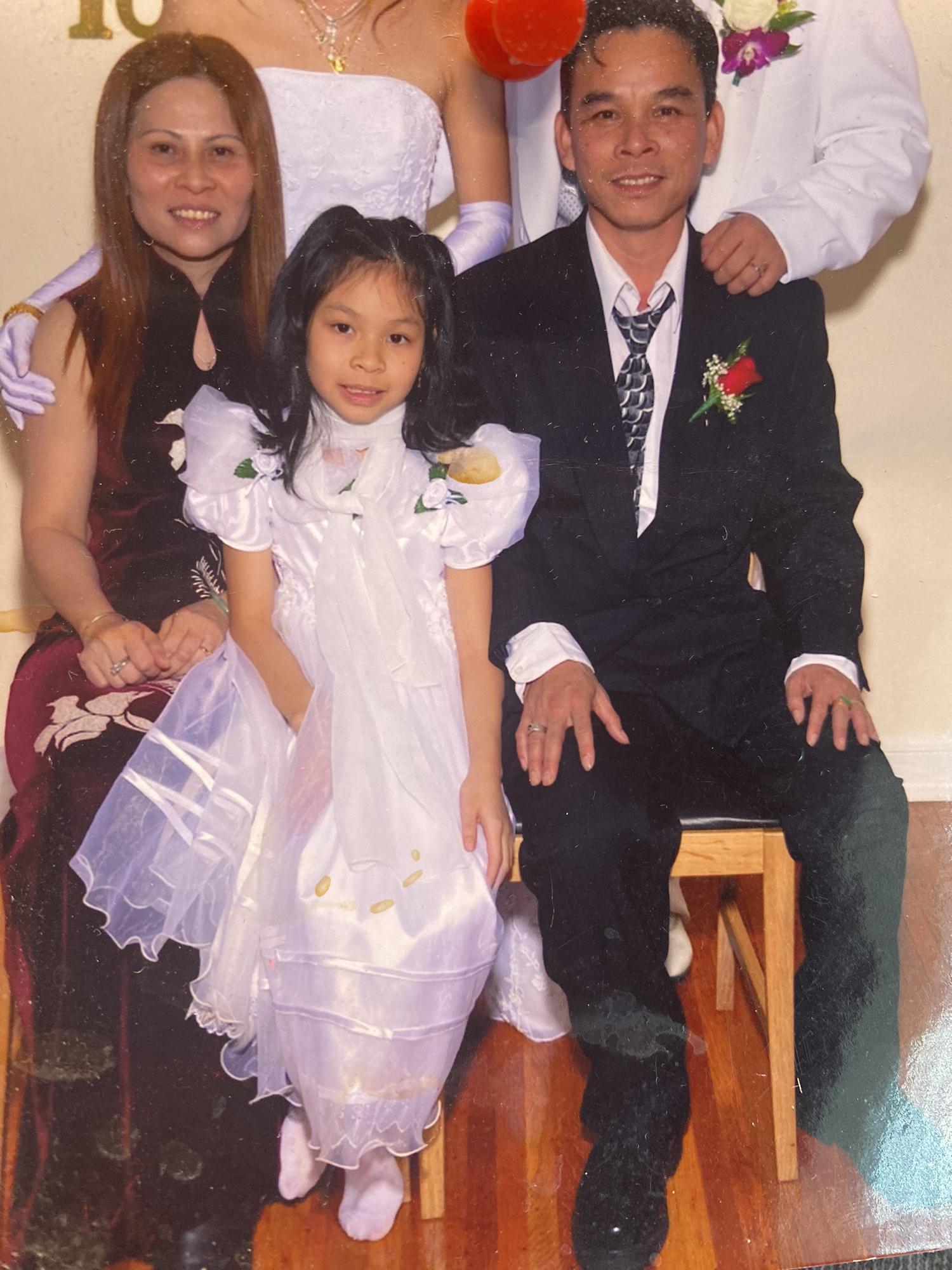 Michelle as a flower girl with her parents, 2003
