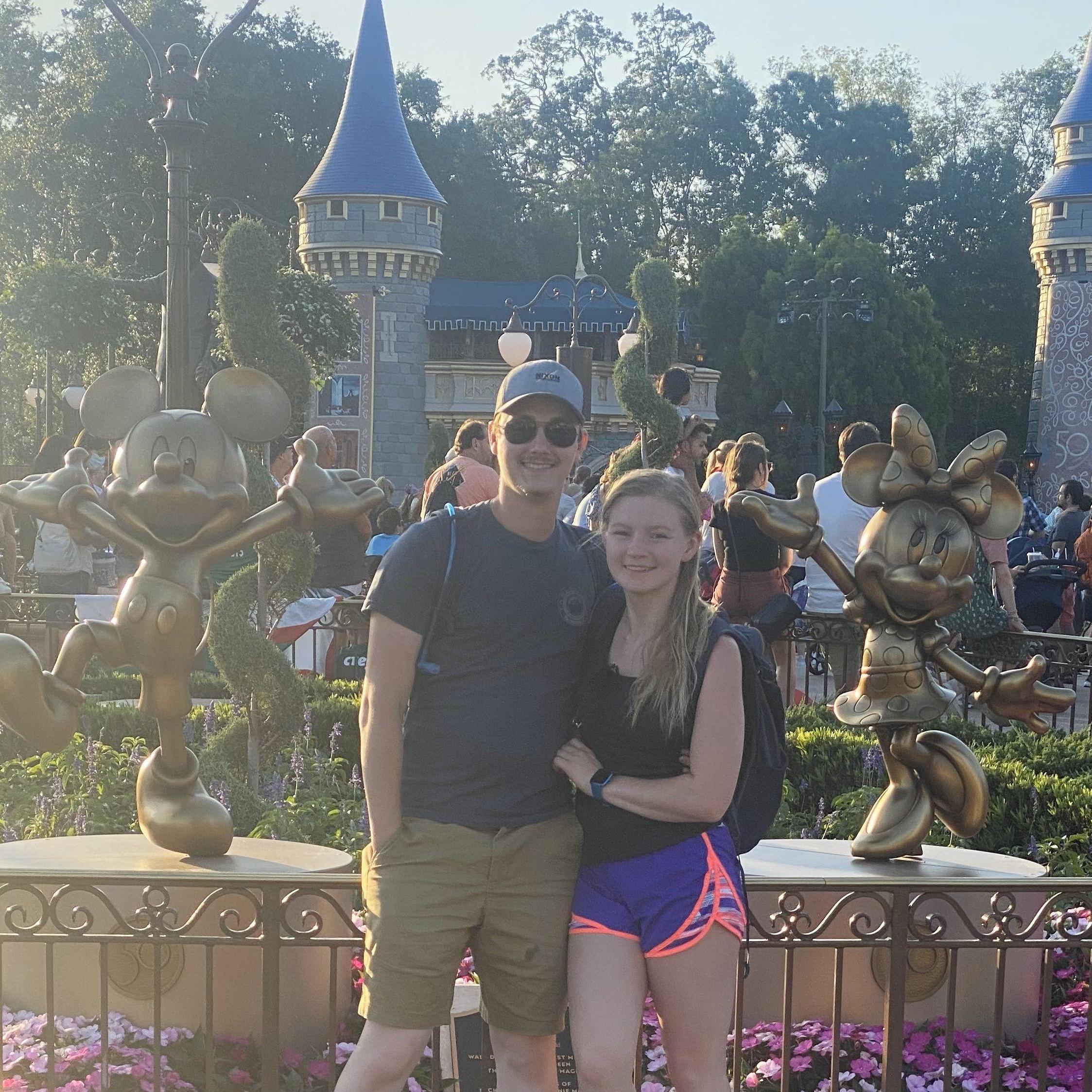 Between Mickey and Minnie Mouse at Disney.