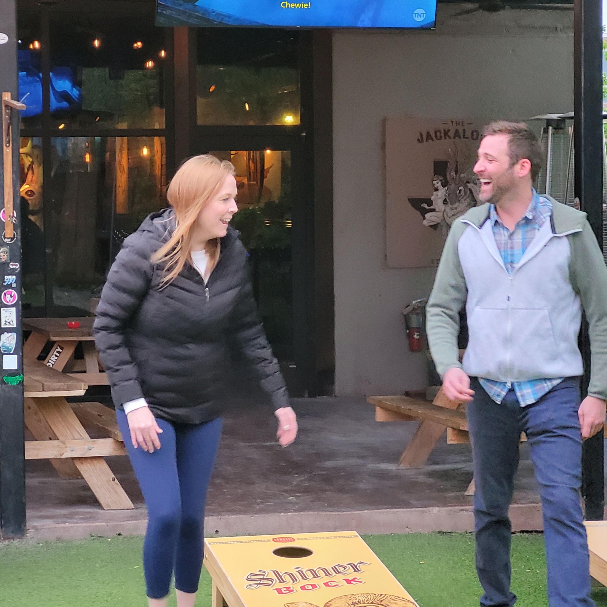 Always laughing - unsure who's talking smack to who in cornhole.