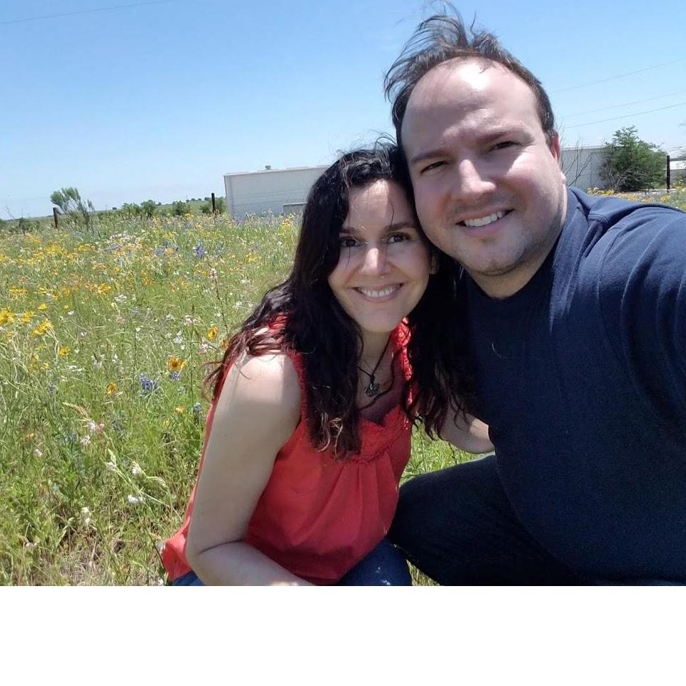 Two love birds among the Texas wild flowers, "somewhere you feel free."