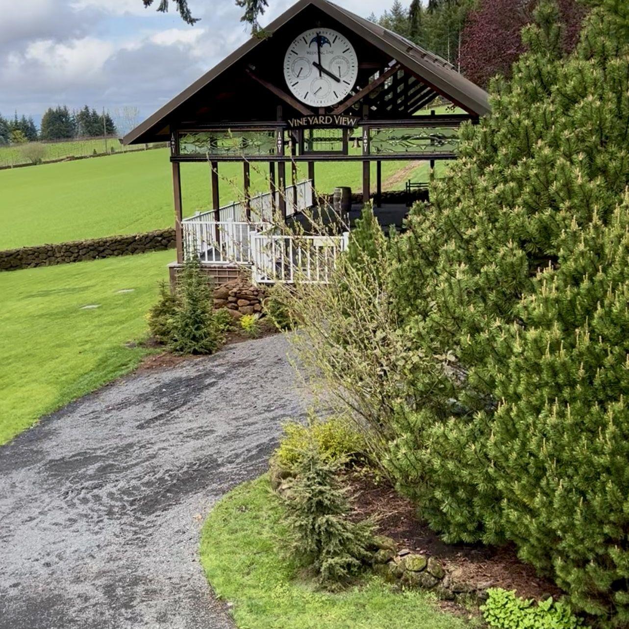 Gravel path to covered reception area and ceremony location on the grass.