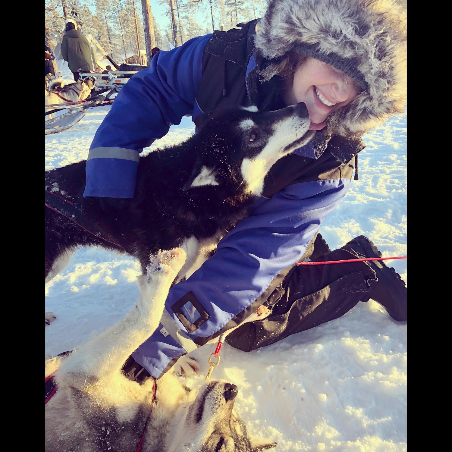 Emilie in her happy place - dog sledding in Finland.