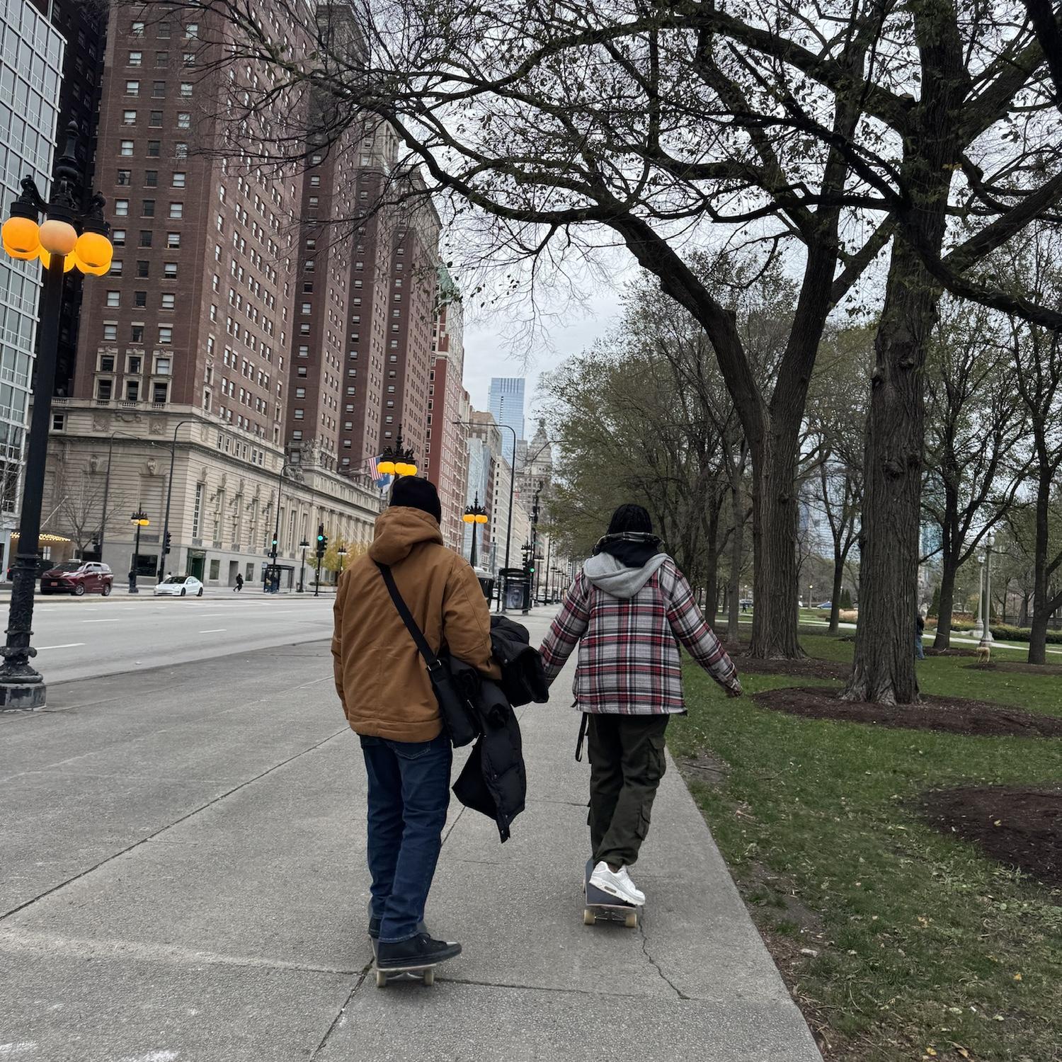 Cosme teaching Naimah how to skateboard