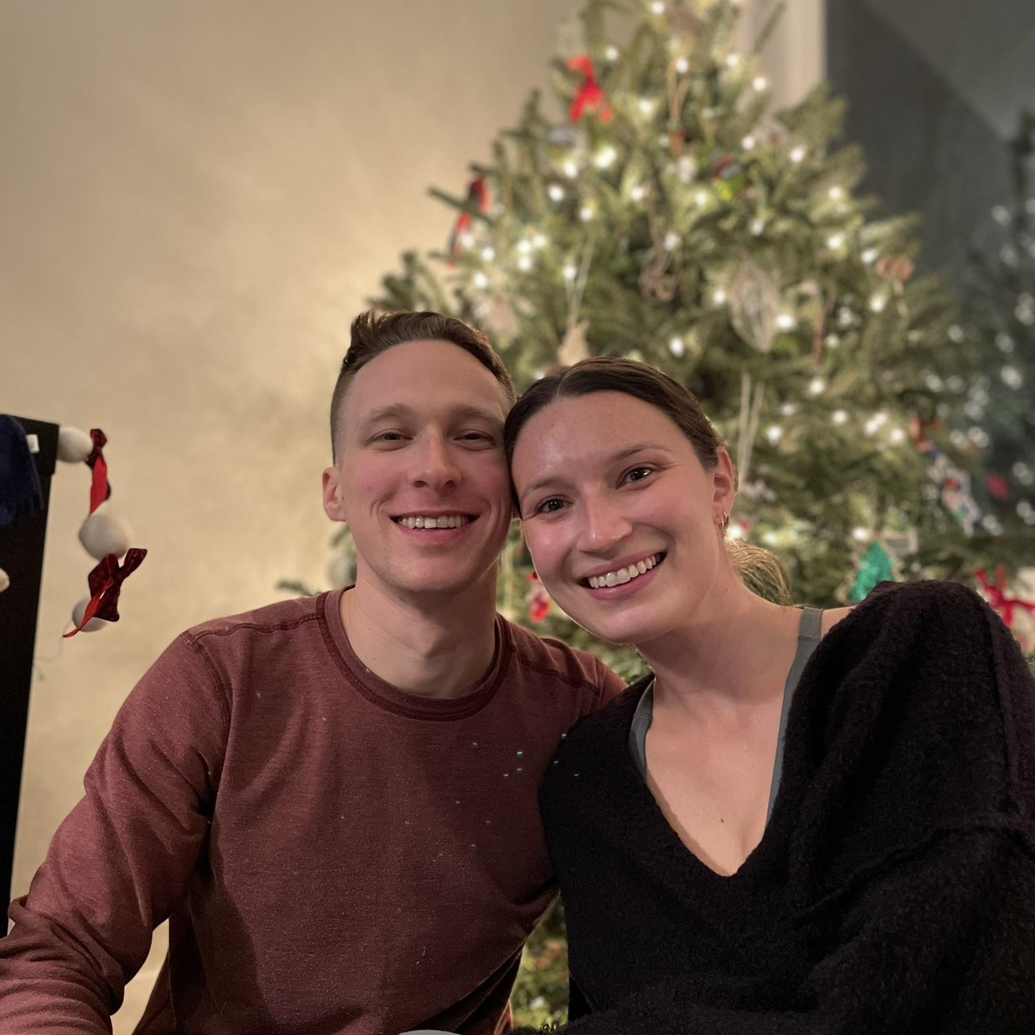 O & K in front of their first Christmas tree in their apartment. Olivia convinced Keegan that they will be getting a real tree each year!