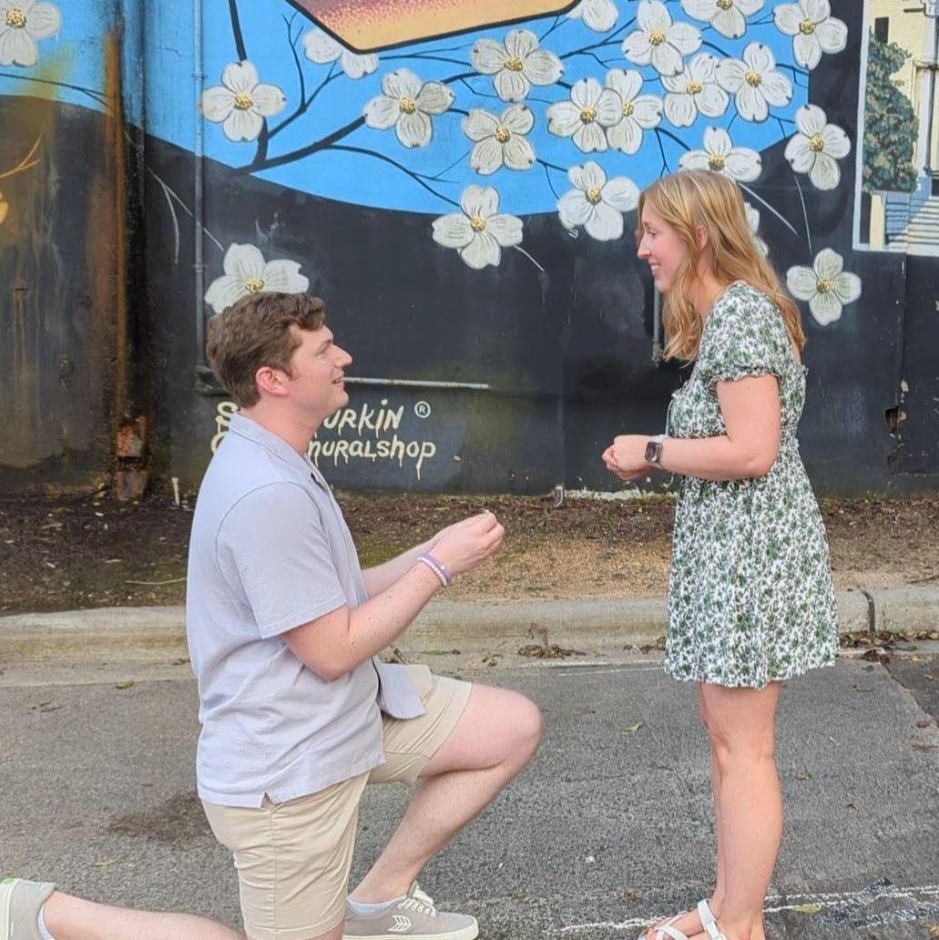 On August 10, Brighton proposed to Sarah at the Chapel Hill postcard mural -- one of the stops on their first date together back in 2016. This time, they were met by friends and family to celebrate!