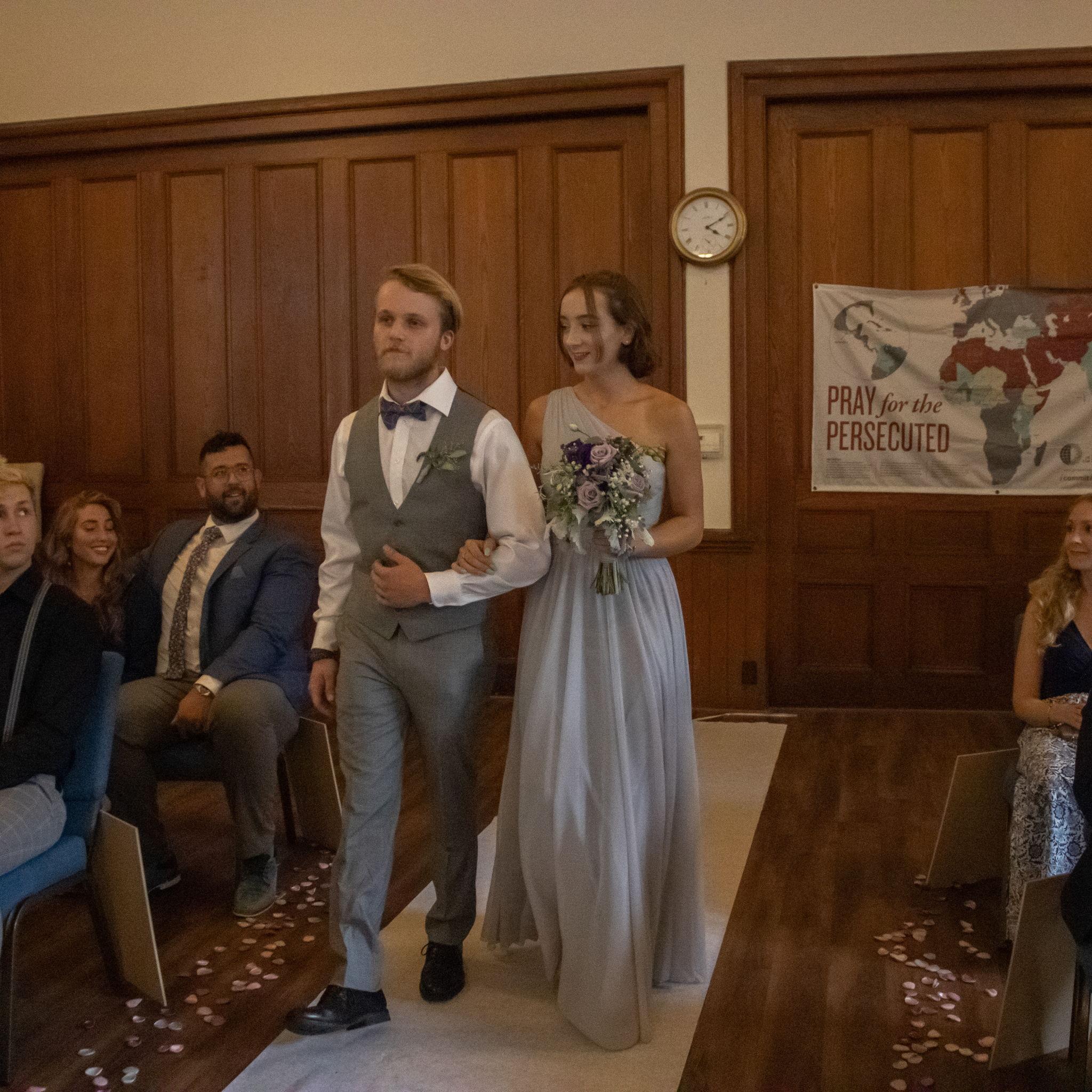 Us walking down the aisle as "Maid of Honor" and "Best Man" in our Matron of Honor and Best Man's wedding