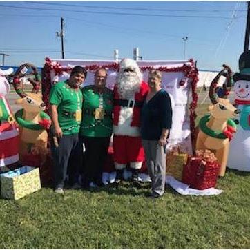 Murby, Terri, and Jubal donating toys.