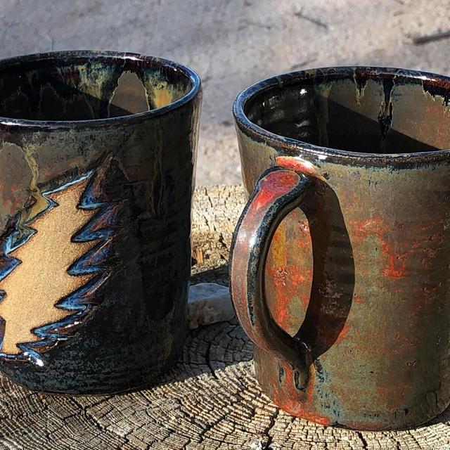 mug/cup with dead head bolt bas relief