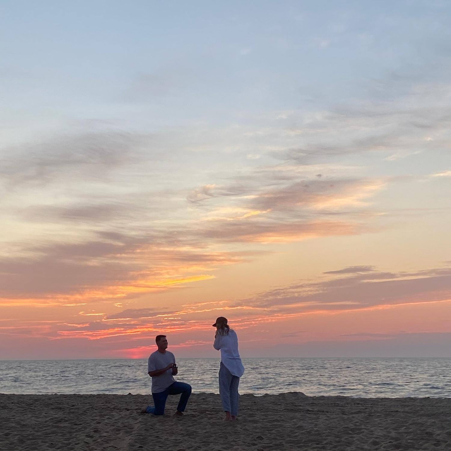 Joey down on one knee, asking Allie to marry him, with a beautiful sunrise behind them.