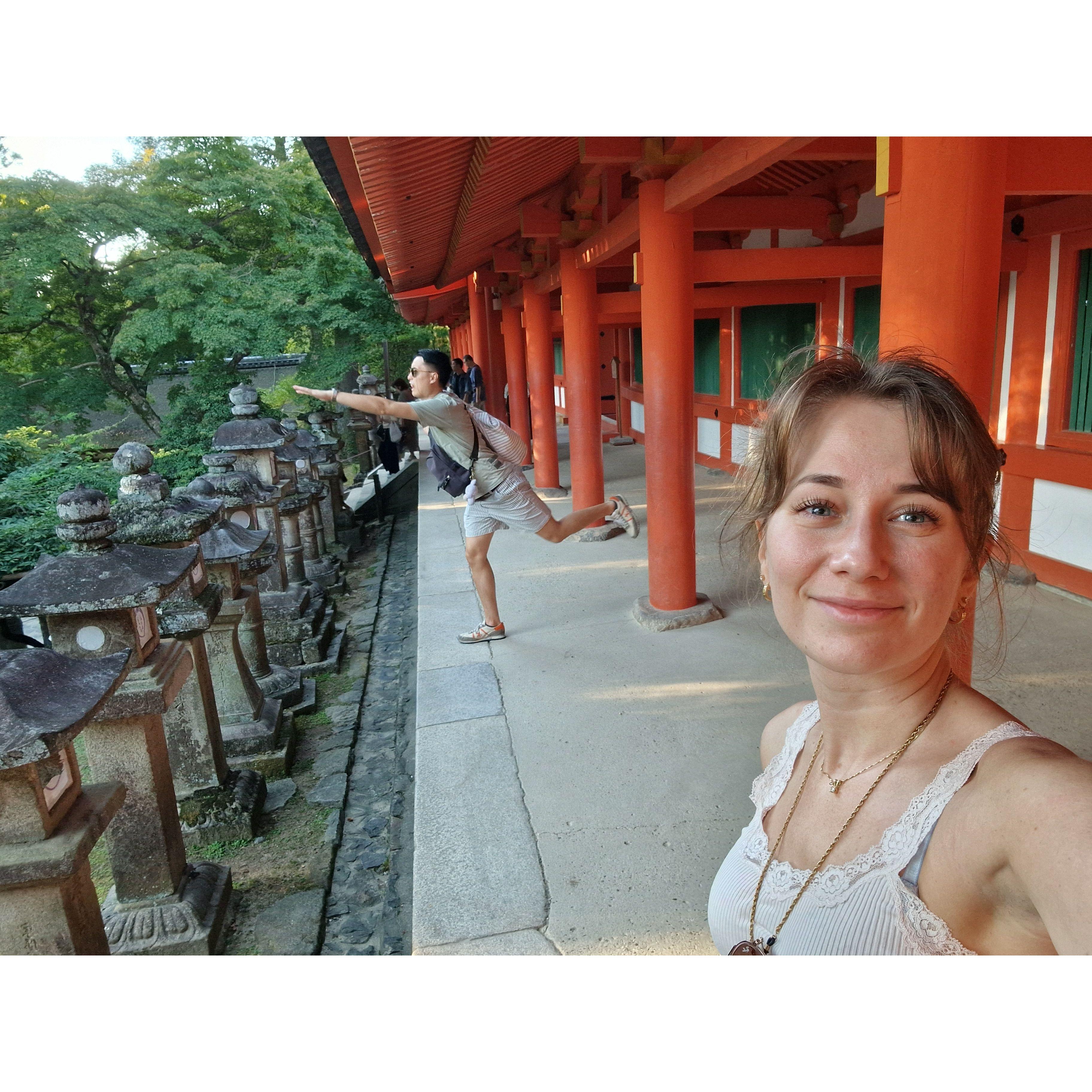 Jonas attempts at doing superman or yoga stances at shrines in Nara, Japan.