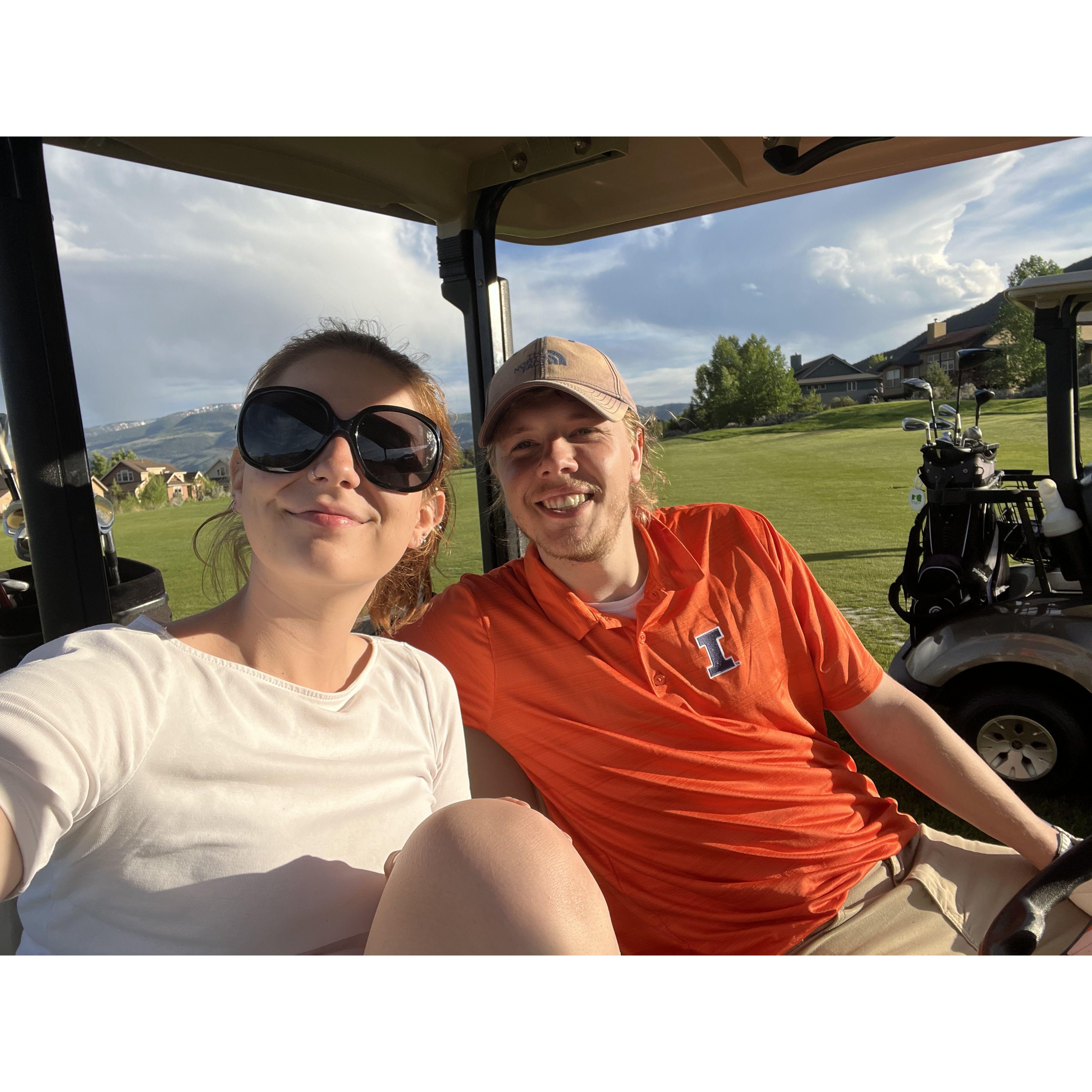 Joe likes to golf, and Ashley likes to ride along in the golf cart with a drink!