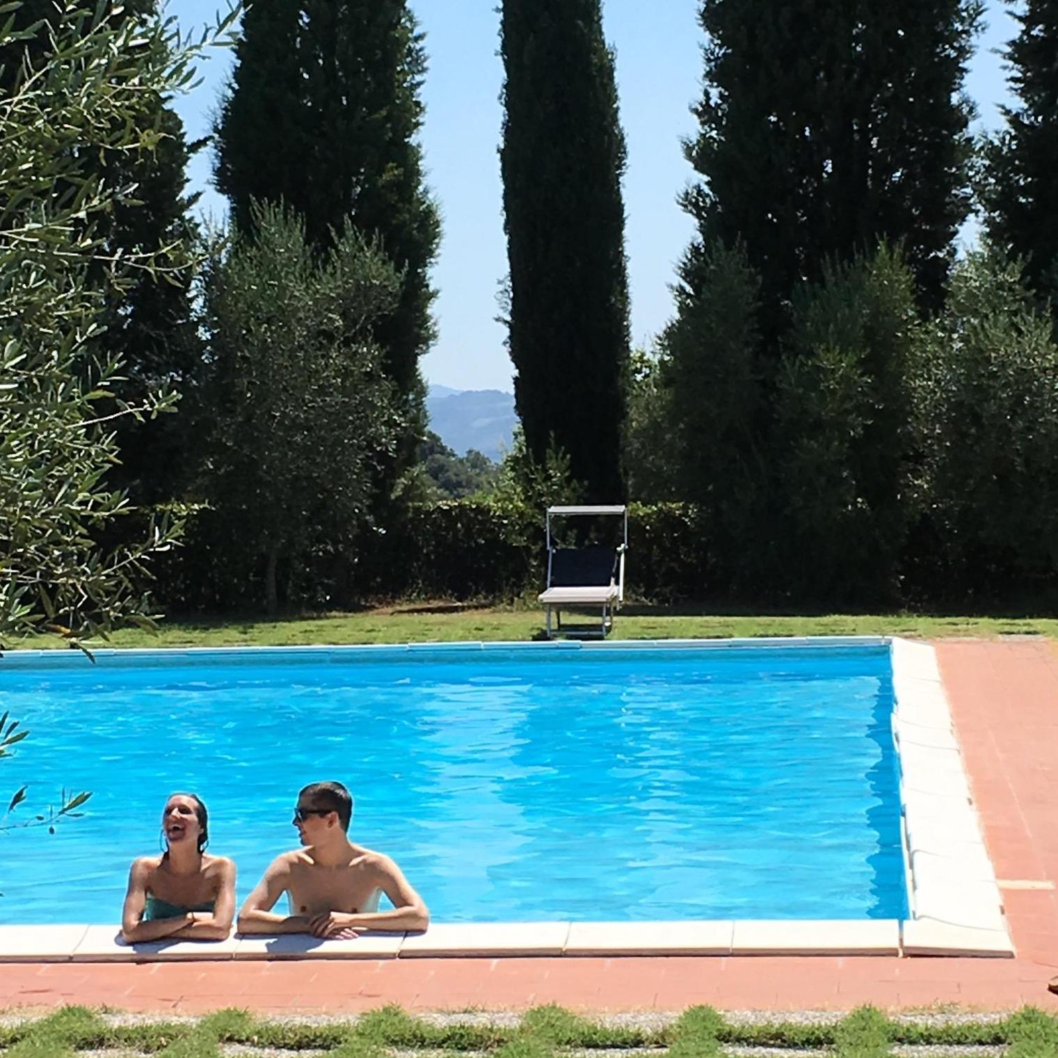 Maddy telling a joke at the pool in Tuscany, Italy, 2016.