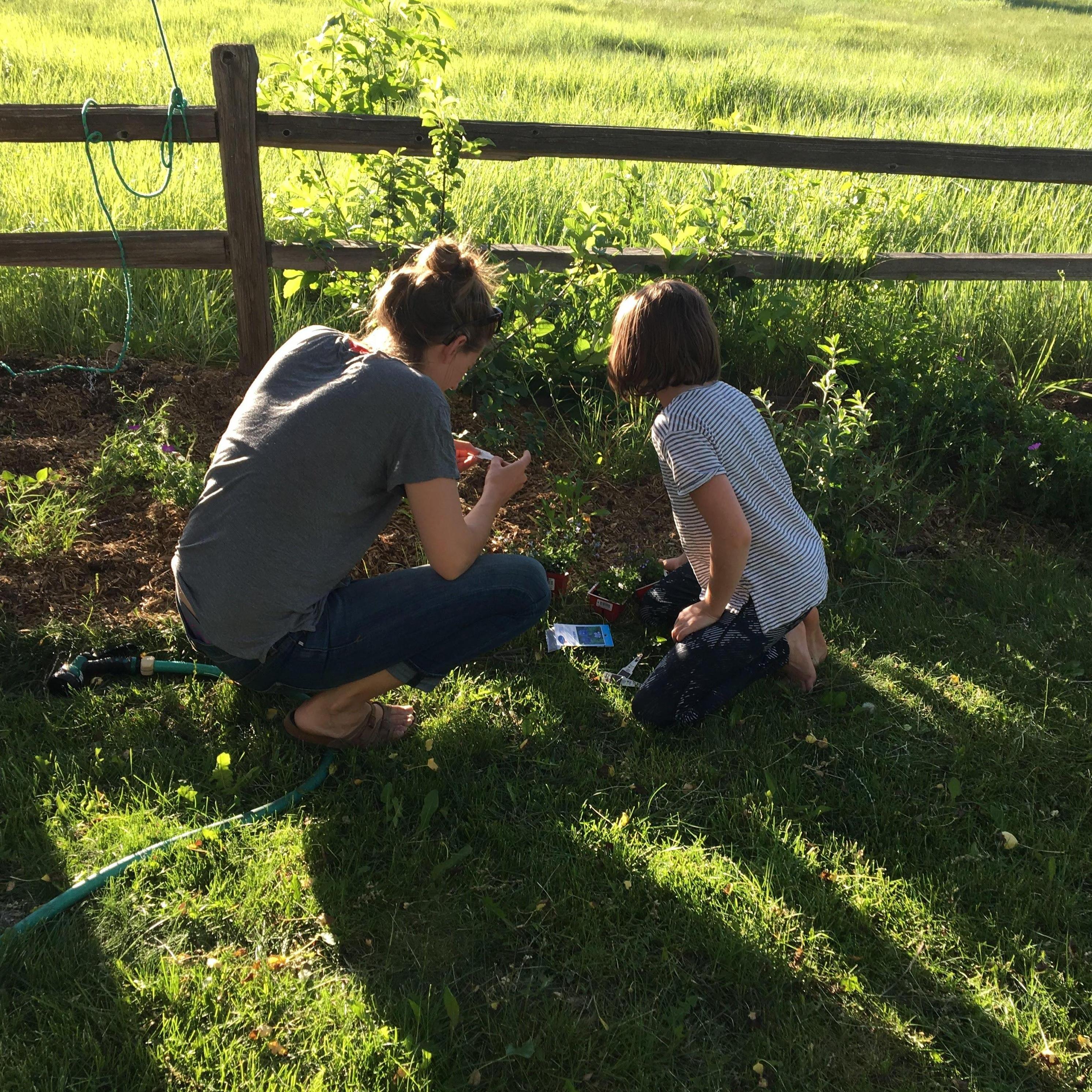 Marcy and Emi adding wild flowers to Mom's/Janet's garden