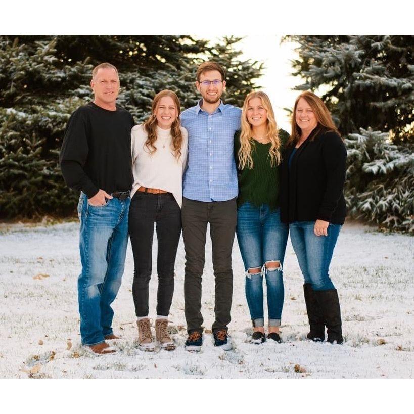 Bryce with his parents, Brian & Leann, and sisters, Bailey (left) & Brooke (right), behind his childhood home in the cold Nebraska snow.