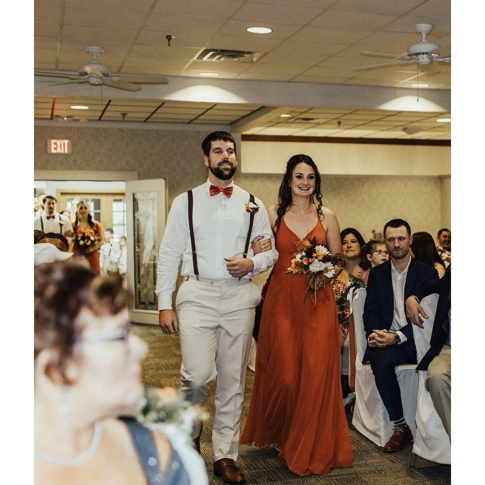 Walking down the aisle together at our best friend's wedding! October 2022