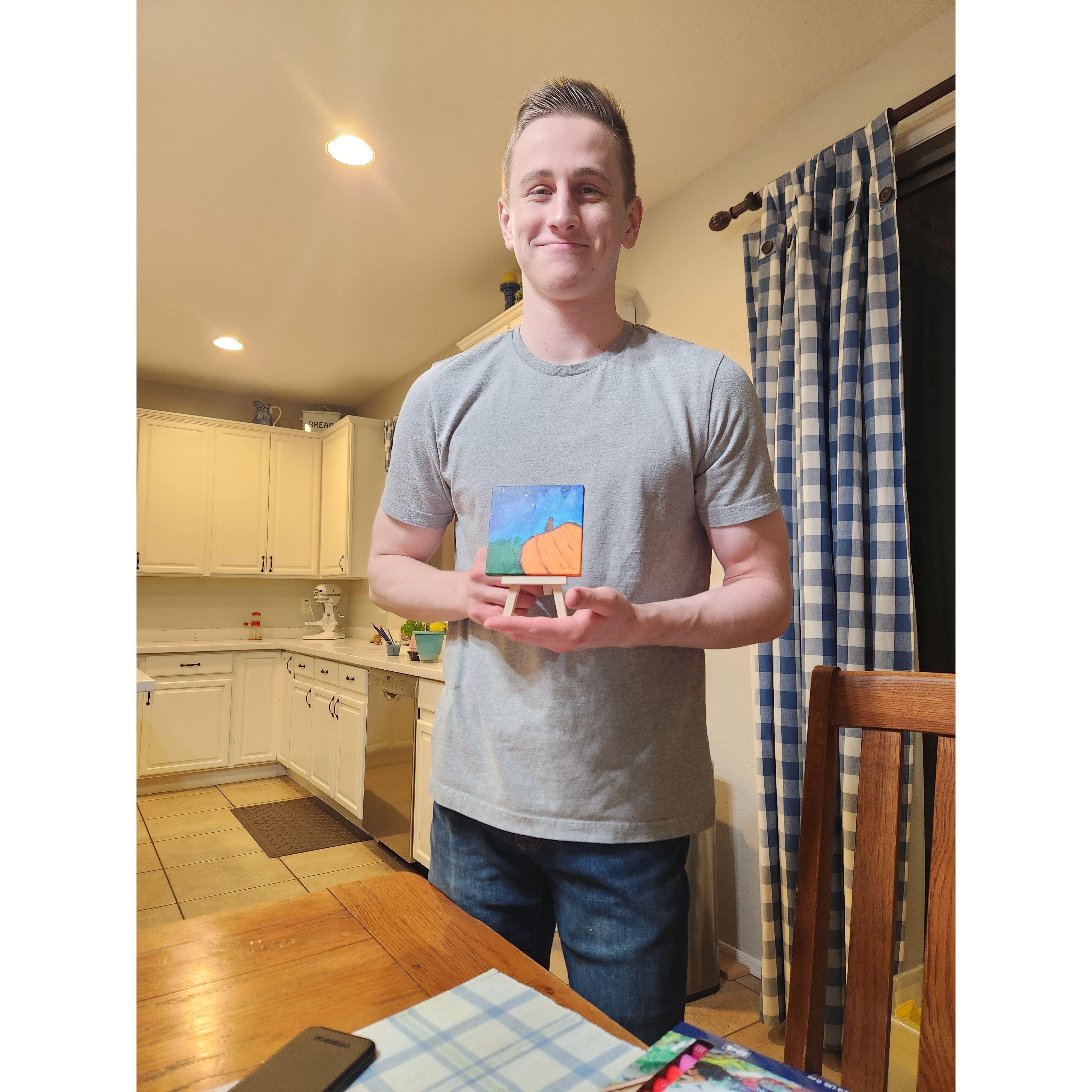 Him with his lil pumpkin painting he made.