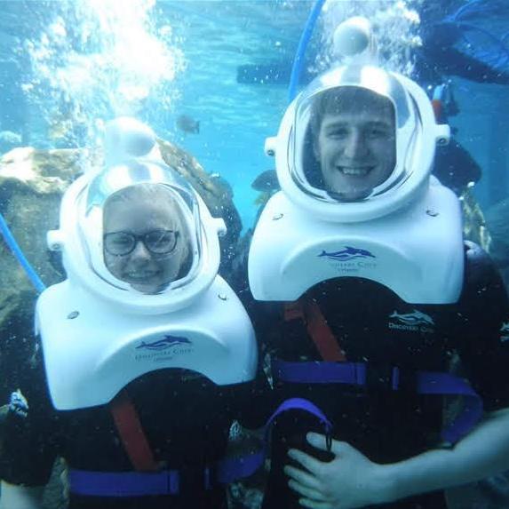first they put these really big helmets on us so we could breathe under water and then they lowered us down into freezing cold water