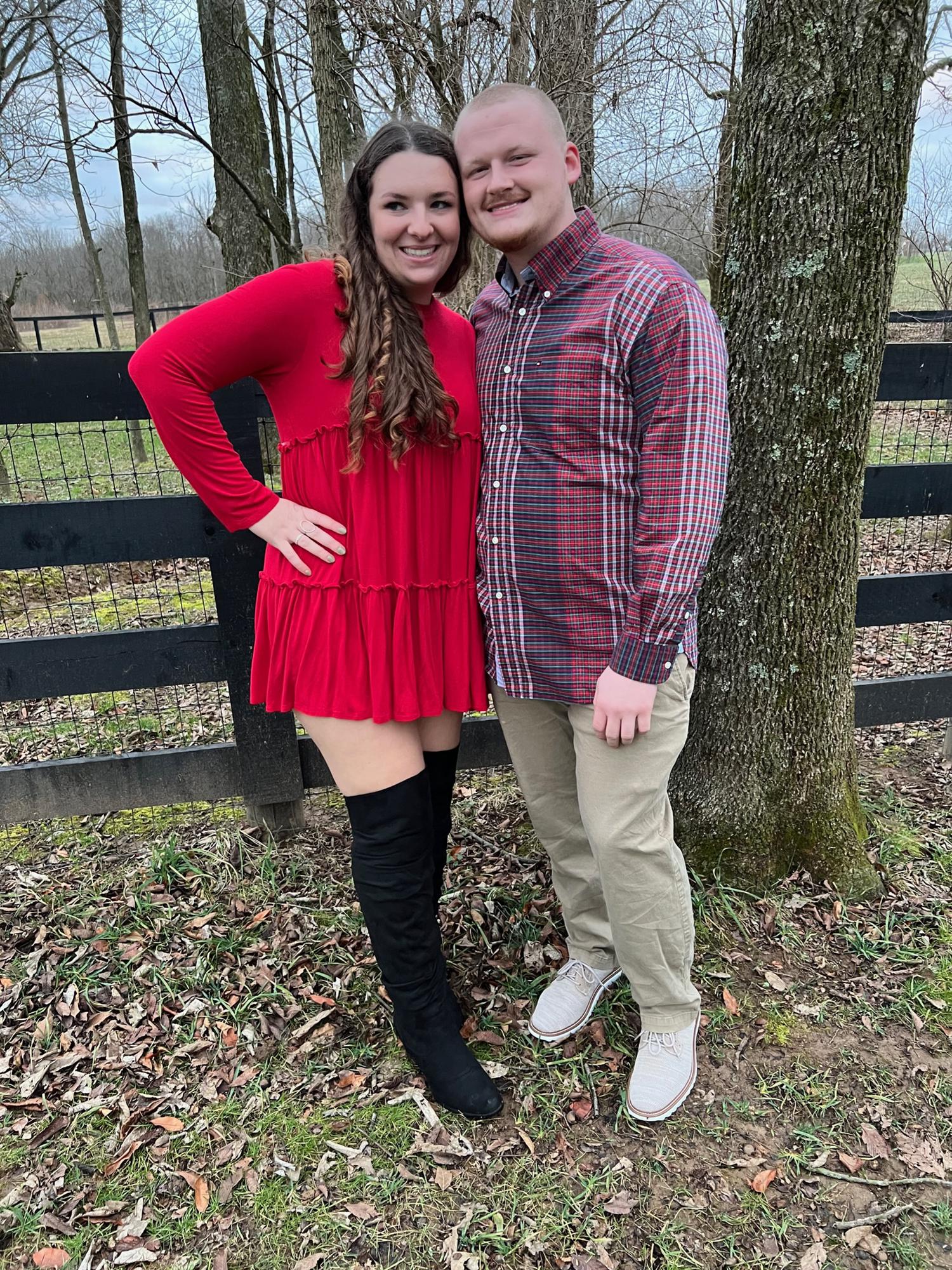 Sydney is clueless that she would be getting proposed to shortly after this photo and is being distracted by her family staring at them while getting their pictures taken.
