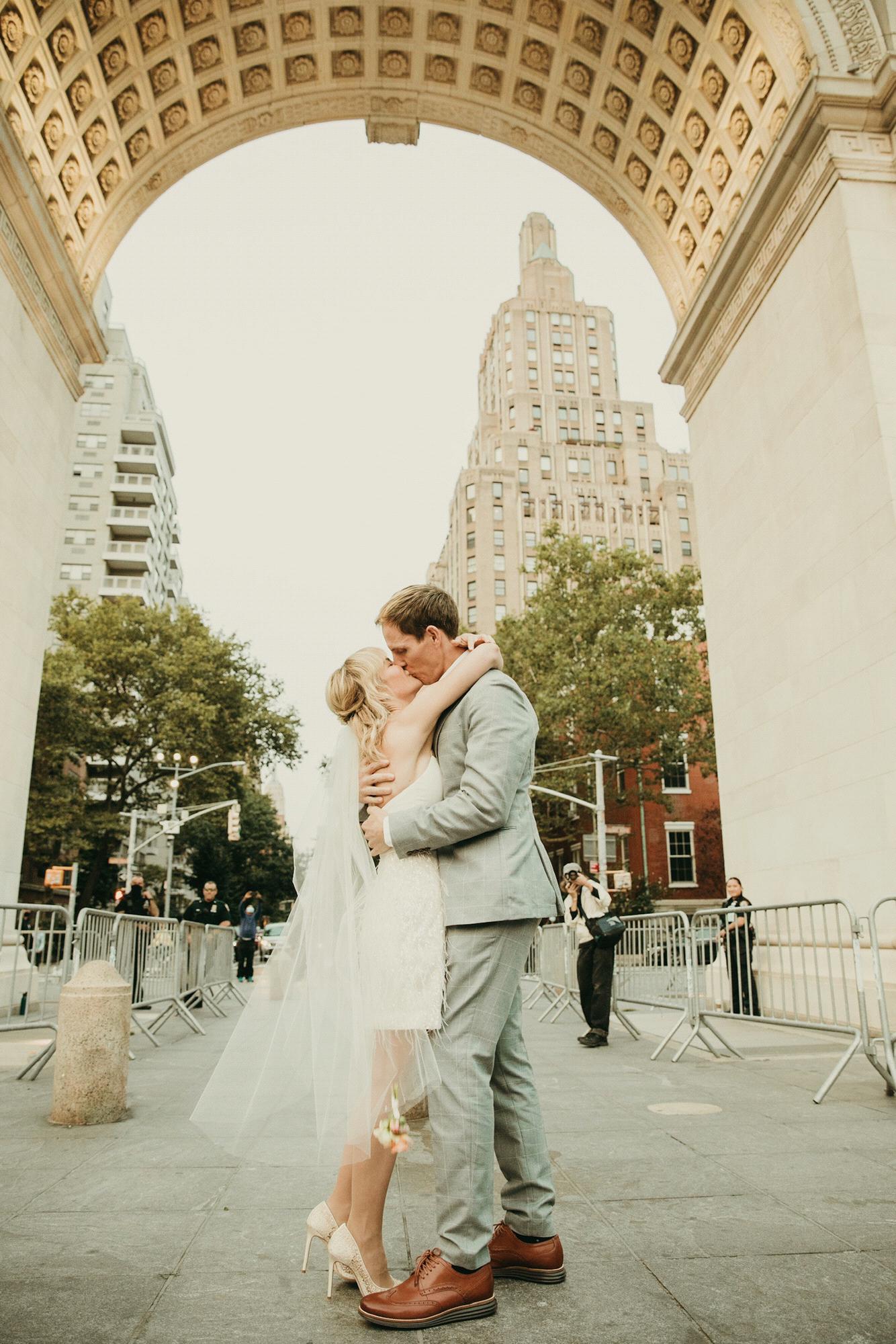 Our first kiss as a hitched couple! Onlookers include one stray photographer and the NYPD.