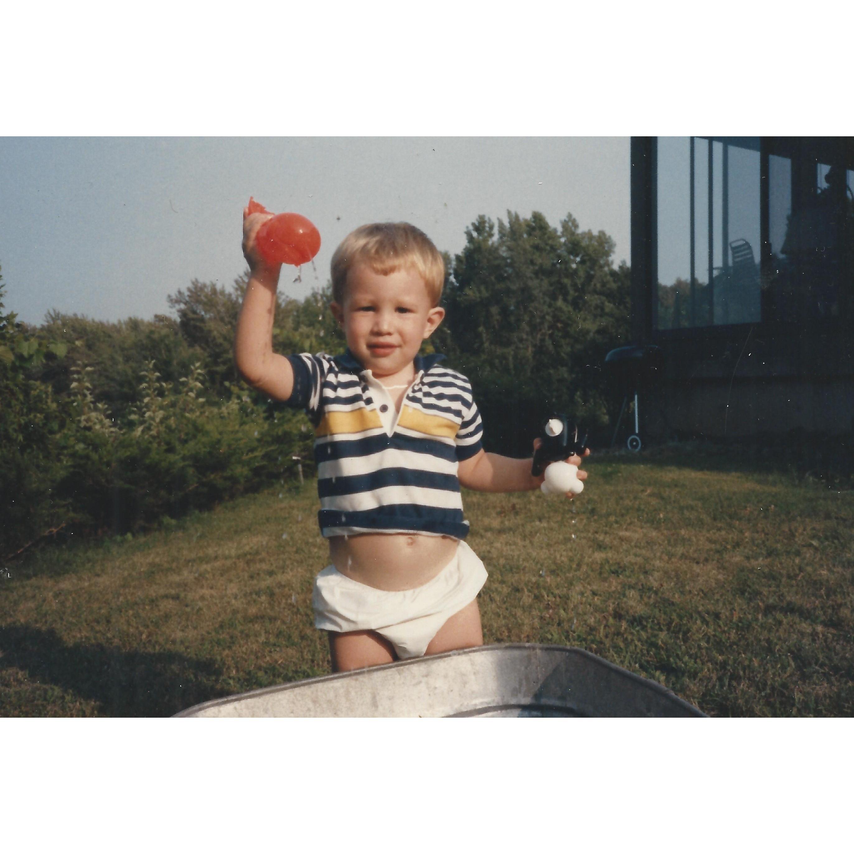 Baby Chavo with a water balloon